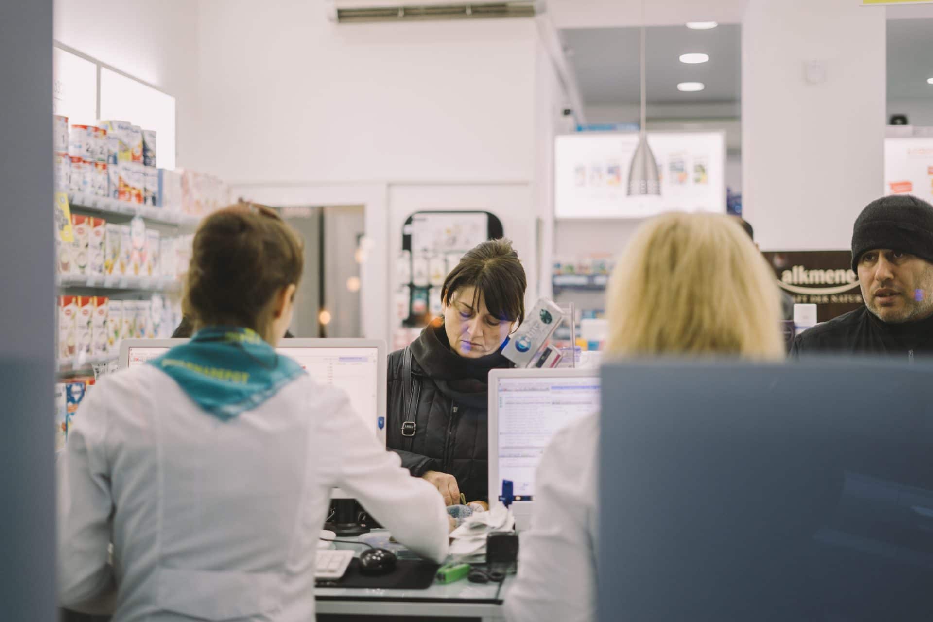 Picking up a prescription at a pharmacy In order to comment on national healthcare, we must define healthcare.